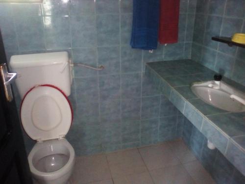 a bathroom with a toilet and a sink at Ashari Hotel in Shanzu