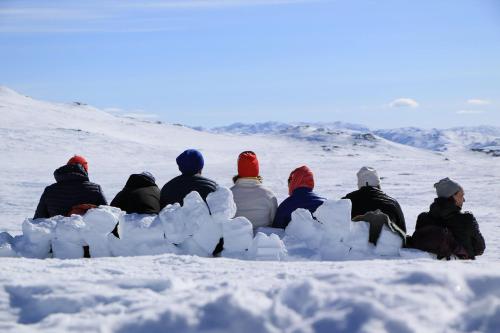 a group of people sitting in the snow at Hovden Fjellstoge in Hovden