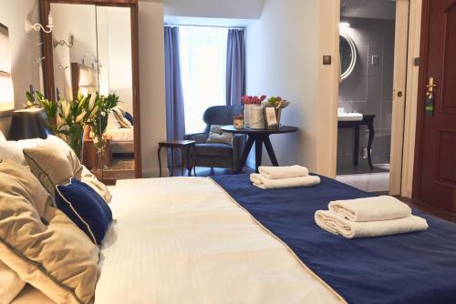 a hotel room with a bed with towels on it at Nobilton Hotel in Kraków