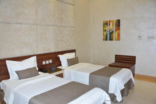 Posteľ alebo postele v izbe v ubytovaní Mandarin Hotel Apartments