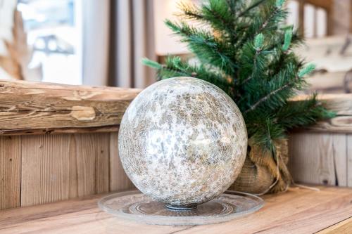 a christmas ornament on a table next to a christmas tree at LandererMühle in Lenggries