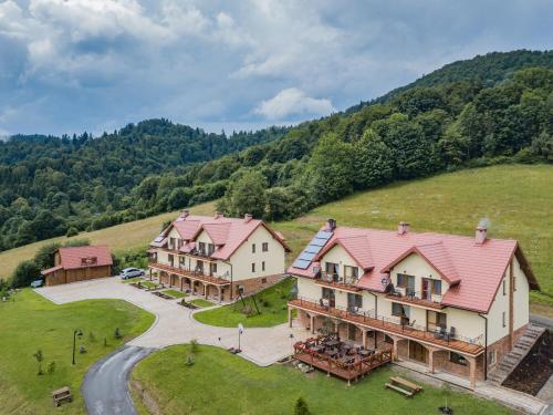 an aerial view of a house on a hill at Pod Brzozka in Cisna