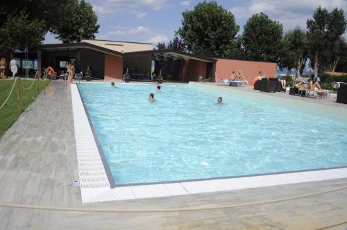 a large swimming pool with people in the water at Camping Listro in Castiglione del Lago