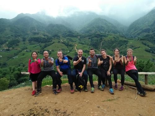 a group of people standing on top of a mountain at ChienDe Homestay in Sa Pa