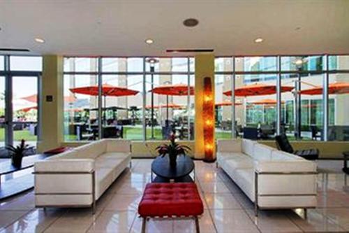 a lobby with couches and umbrellas in a building at University Plaza Waterfront Hotel in Stockton