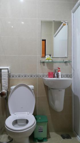 a bathroom with a white toilet and a sink at Tomorrow Hostel Vũng Tàu - Tomorrow Homestay in Vung Tau