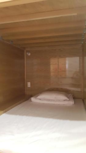 a small bed in a wooden bunk bed room at Tomorrow Hostel Vũng Tàu - Tomorrow Homestay in Vung Tau