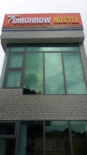 a building with a sign on top of it at Tomorrow Hostel Vũng Tàu - Tomorrow Homestay in Vung Tau