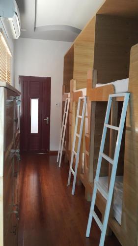 a room with two bunk beds and two ladders at Tomorrow Hostel Vũng Tàu - Tomorrow Homestay in Vung Tau
