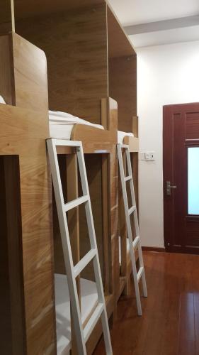 a bunk bed in a room with two ladders at Tomorrow Hostel Vũng Tàu - Tomorrow Homestay in Vung Tau