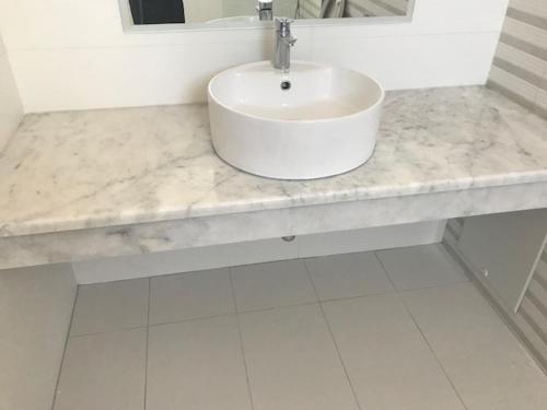 a bathroom counter with a sink and a mirror at Floral Studios in Kefalos