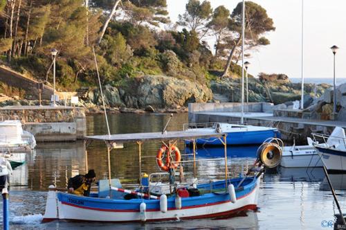 a small boat is docked in a harbor at Villa ALFONSA in Saint-Raphaël