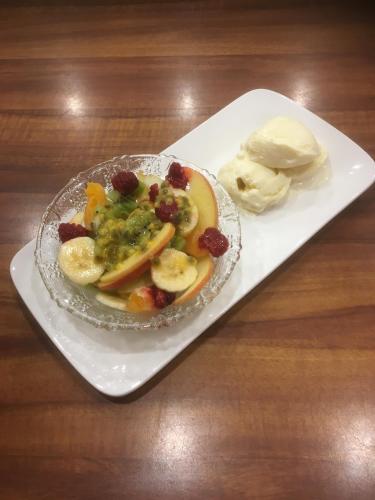 a plate of food with bananas and fruit on a table at House on the Hill Bed and Breakfast in Huonville