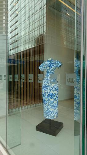 a blue and white vase on display in a window at IW Hotel in Hong Kong