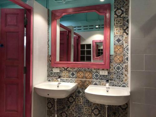 a bathroom with two sinks and a mirror at Stash in Bangkok