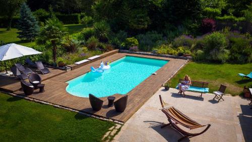 une vue aérienne d'une piscine dans une cour arrière dans l'établissement Gite la Maison de la Pimpine Lignan de Bordeaux, à Lignan-de-Bordeaux