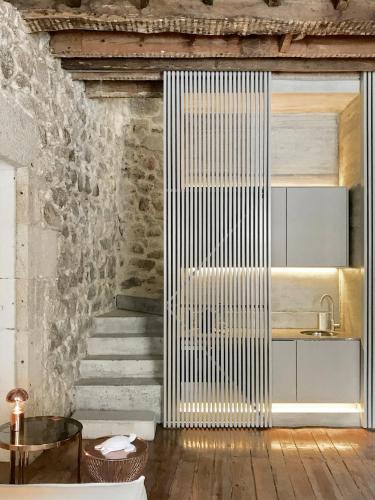 a living room with a staircase and a table at Element in Viseu