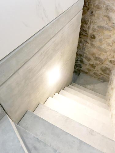 a set of stairs in a room with a stone wall at Element in Viseu