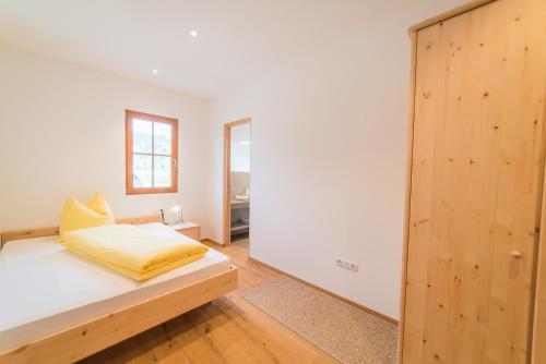 a bedroom with a bed and a mirror at Bauernhof Residence Hausergut with Ortler views, central and quiet position in Sluderno
