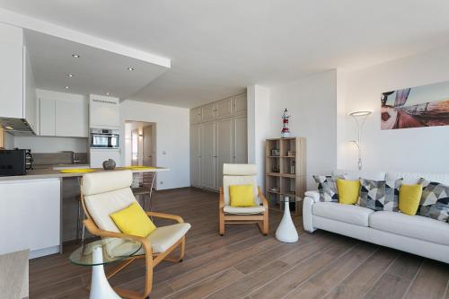 a kitchen and a living room with a couch at Apartment V7 in Ostend