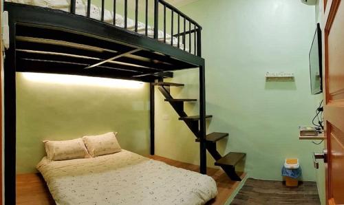 a bedroom with a bunk bed and a staircase at 幸福轩&幸福一家民宿 Happiness Family Homestay in Bagan Pulau Ketam