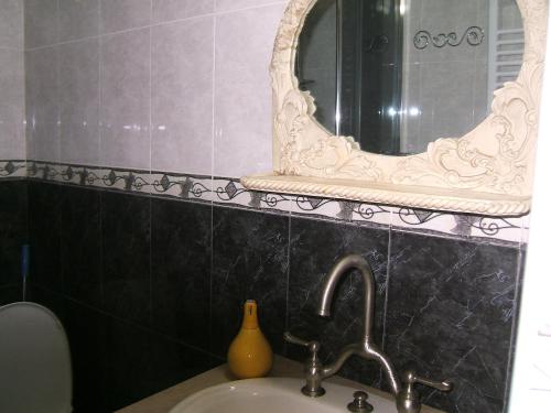 a bathroom with a sink and a mirror at Tina's Homestay in Tbilisi City