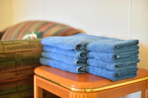 a pile of blue towels sitting on a table at PANORAMA Ocean View Cottage in Motobu