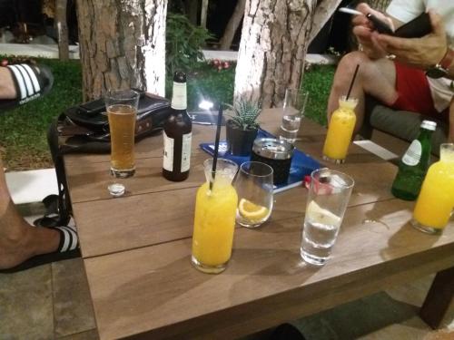 a wooden table with bottles and glasses of orange juice at Apartmani Vila Marija in Budva