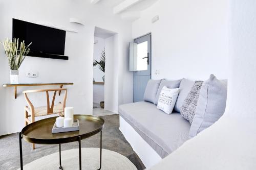 a living room with a couch and a table at Living Theros Luxury Suites in Kardiani