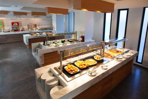 a buffet line with many different types of food at Pefkos City Hotel in Limassol