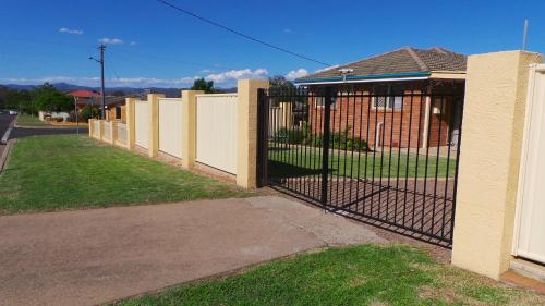 a fence in front of a house at The Garden House in Tamworth
