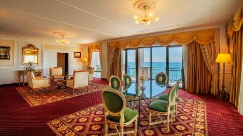 a hotel room with chairs and a room with a view at Kobuleti Georgia Palace Hotel & Spa in K'obulet'i