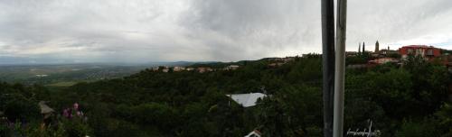 a view of a hill with trees and a city at Abramichi Guest House in Sighnaghi