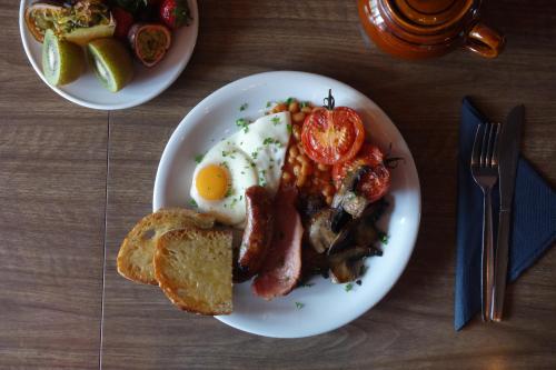 a plate of breakfast food with eggs bacon and toast at Hotel Pelirocco in Brighton & Hove