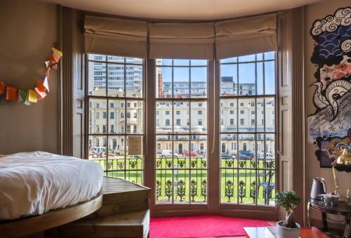 a bedroom with a large window with a view of a city at Hotel Pelirocco in Brighton & Hove
