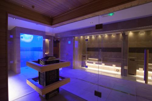 a bathroom with a shower with purple lighting at Netherwood Hotel & Spa in Grange Over Sands
