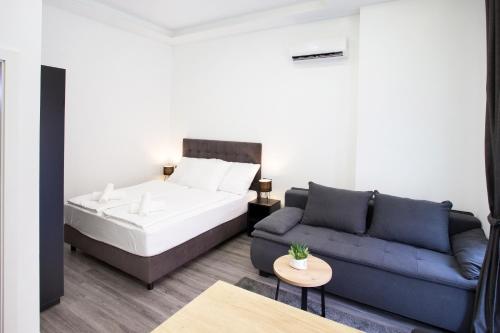 a living room with a bed and a couch at SENZACIJA apartments in Split