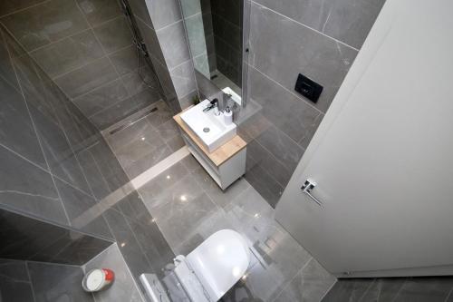 a small bathroom with a sink and a toilet at SENZACIJA apartments in Split