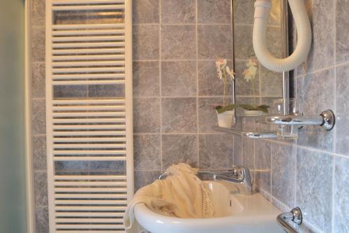 a bathroom with a sink and a mirror at Casa il Balconcino - WelcHome in Cannobio