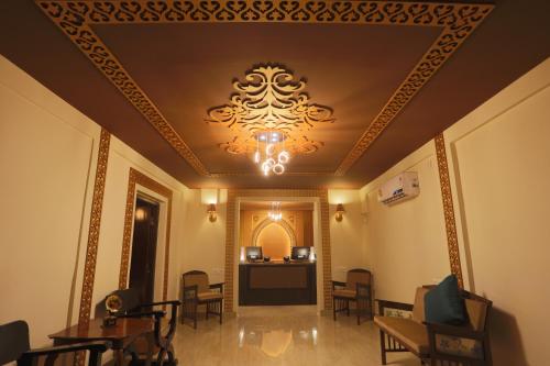 a room with a ceiling with a chandelier at Sinon Baga Retreat in Baga