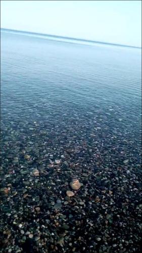 a large body of water with rocks in the water at Vacation Home Nukri in Gonio