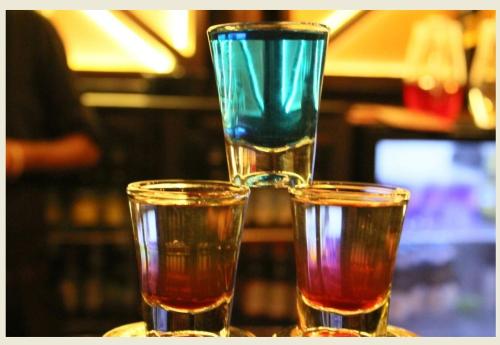 three different colored glasses sitting on top of a table at Sinon Baga Retreat in Baga