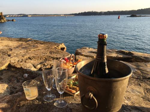 a bottle of champagne in a bucket with wine glasses at Le Pas Saint Joseph in Saint Malo