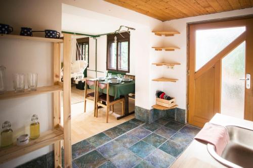a kitchen with a sink and a table in a room at Nature nook in Bled