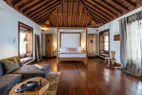 a living room with a couch and a bed at Hotel Boutique Palacio Ico - Only Adults in Teguise