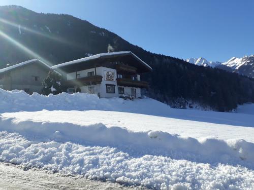 a pile of snow in front of a building at Appartement Wildkogelblick in Neukirchen am Großvenediger