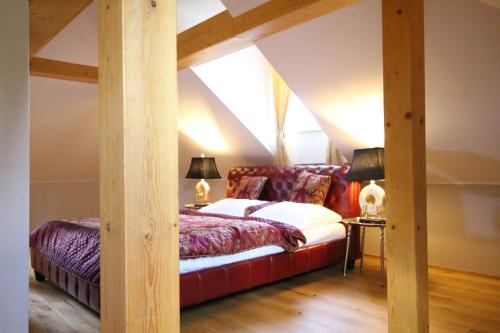 a bedroom with a bed in a attic at Hotel Panství Dlouhá Lhota in Dlouhá Lhota