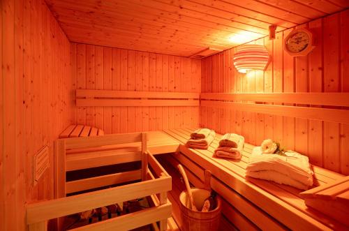 a sauna with wooden walls and wooden shelves at Ferienwohnung Weisbrod, nur private Buchungen in Bräunlingen