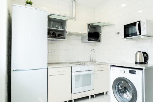 クルガンにあるApartment in Kurganの白いキッチン(洗濯機、洗濯機付)