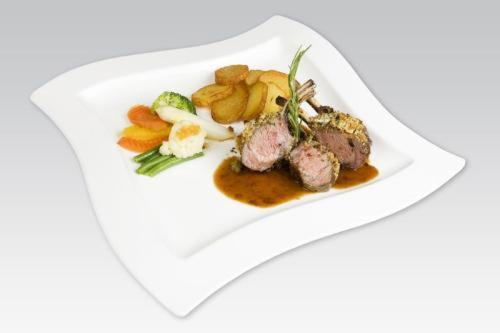 a plate of food with meat and vegetables on it at Landhotel Föhrenhof Ellmau in Ellmau